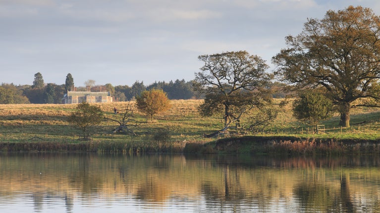 View of the lake and parkland with Felbrigg Hall in the distance
